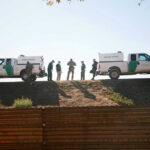 Fentanyl Plot Twist At The Border Border Patrol vehicles and agents on a ridge.