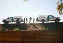 Fentanyl Plot Twist At The Border Border Patrol vehicles and agents on a ridge.