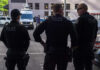 Court Smacks Stop‑And‑Frisk Overreach Three police officers standing on a city street.