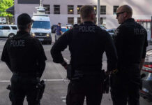 Court Smacks Stop‑And‑Frisk Overreach Three police officers standing on a city street.