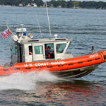 Coast Guard boat speeding on the water.