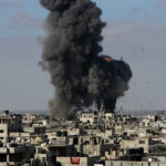 Large explosion over a crowded urban area.