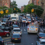 NYC Park Motorcycle Chaos Police activity on a city street with emergency vehicles.