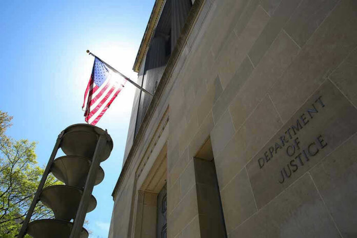 2152403209-1 American flag at Department of Justice building exterior.