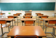 Judge Blasts ‘Predatory’ Teacher Empty classroom with desks and a chalkboard.