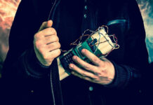 Person holding a homemade explosive device.