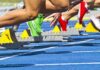 Supreme Court Earthquake Hits Women’s Sports Athletes starting a sprint from starting blocks on a blue track