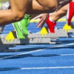 Supreme Court Earthquake Hits Women’s Sports Athletes starting a sprint from starting blocks on a blue track