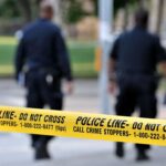 Impostor Panic: DEA Badge, Guns, Chemicals Police officers walking past caution tape at a crime scene