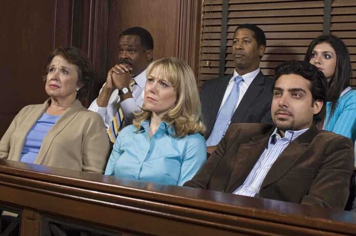 shutterstock_121503358 A diverse group of jury members sitting in a courtroom with serious expressions