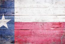 Texas flag displayed on a wooden background