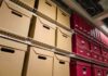 Shelves filled with brown and red storage boxes for organizing documents