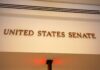 Senate Drops $70B Border Hammer Sign displaying United States Senate in a government building