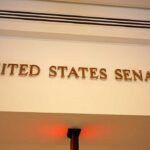 Senate Drops $70B Border Hammer Sign displaying United States Senate in a government building