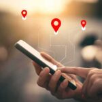 Phone Data Dragnets SMACKED Down Person using a smartphone with location markers displayed on the screen