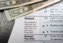Ghost Firms Grab $6B — Clock Ticks Close-up of tax refund form with cash on a wooden surface
