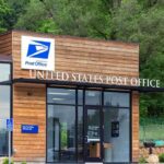 Exterior view of a modern United States Post Office building surrounded by greenery