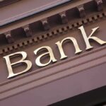 Trump Targets Cartel Cash—Banks Brace Close-up of a bank sign with gold lettering