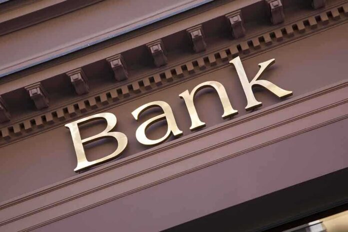 shutterstock_240120346 Close-up of a bank sign with gold lettering