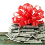 Donor Cash Funneled To Extremists? A stack of cash topped with a red ribbon bow
