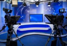 Iran Payday Myth Shredded On Live TV A television studio setup with cameras and a blue backdrop