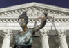 Prosecutor OUSTED Over Wild Love-Triangle Scandal Lady Justice statue in front of courthouse.