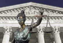 Prosecutor OUSTED Over Wild Love-Triangle Scandal Lady Justice statue in front of courthouse.