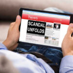Assault Bombshell Upends Maine Senate Race Person reading tablet with headline Scandal Unfolds.
