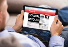 Assault Bombshell Upends Maine Senate Race Person reading tablet with headline Scandal Unfolds.