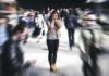 Oregon’s Stunning Abuse Label Sparks Lawsuit Woman covering her face in a busy street