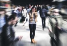 Oregon’s Stunning Abuse Label Sparks Lawsuit Woman covering her face in a busy street