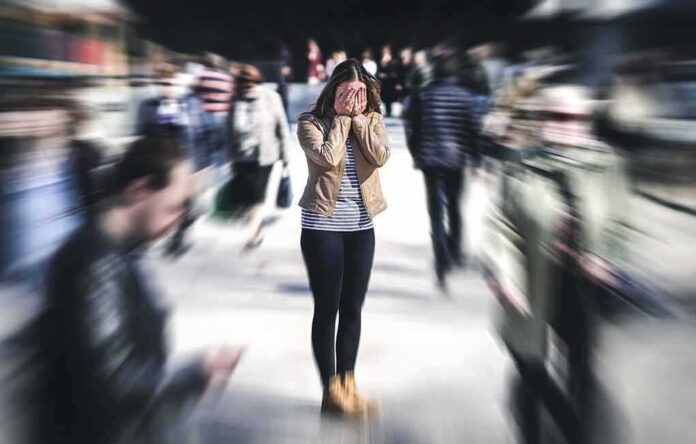 Woman covering her face in a busy street