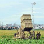 Battlefield Mine Blitz—No Humans Military defense system deployed in a field with soldiers nearby