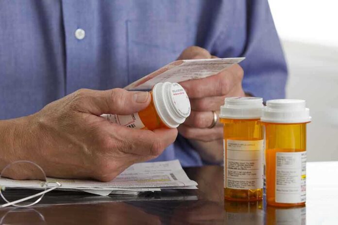 shutterstock_143469949 Person holding a prescription bottle and reading medical instructions