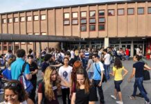 Nine Overdoses. Board Says No Teacher Testing A large group of students socializing outside a school building