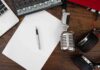 Biden Tapes Greenlit — What’s He Hiding? Podcast workspace with microphone, headphones, and blank paper