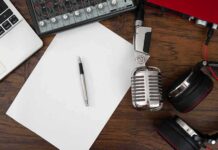 Podcast workspace with microphone, headphones, and blank paper