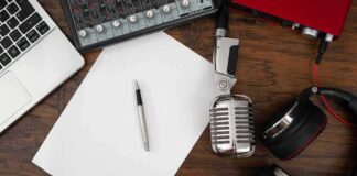 Podcast workspace with microphone, headphones, and blank paper