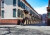 Row houses along a cobblestone street in an urban setting