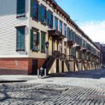 Record High Rents, Now a Freeze—Then What? Row houses along a cobblestone street in an urban setting