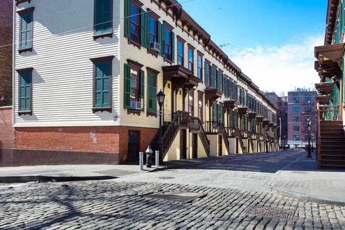 shutterstock_190523168 Row houses along a cobblestone street in an urban setting