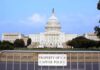 Troops Till 2029: What’s Really Going On? View of the U.S. Capitol building with a security barrier in front