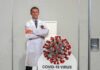 Fauci Crisis After COVID Vaccine Ignites Washington Cardboard cutout of doctor with COVID-19 virus info display