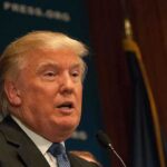 July 4 Shock: Trump Dials Putin, Zelenskyy A public figure speaking at a podium during a press conference