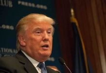 July 4 Shock: Trump Dials Putin, Zelenskyy A public figure speaking at a podium during a press conference