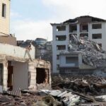 Deadly Quake, Mall Crumples—Why? Collapsed apartment buildings amid heavy rubble