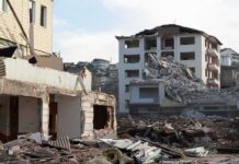 Deadly Quake, Mall Crumples—Why? Collapsed apartment buildings amid heavy rubble
