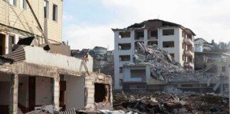 Collapsed apartment buildings amid heavy rubble