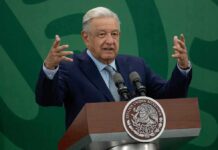 Cartel Moles EXPOSED Inside Mexico’s Ruling Party man at podium speaking with raised hands