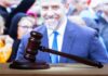 Hunter’s F-Bomb Barrage Hits Trump Heirs judge's gavel on desk with blurred suited man in background